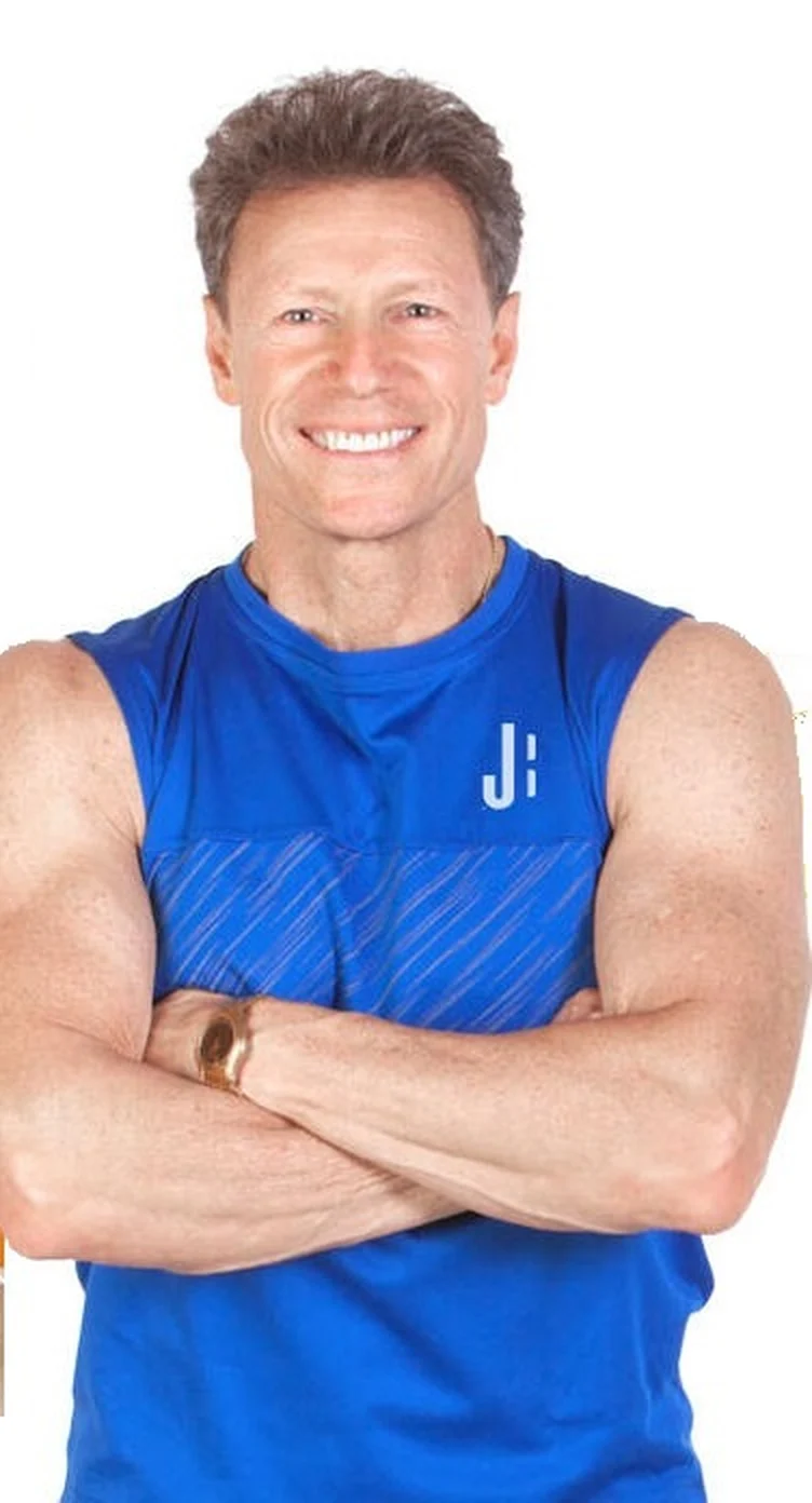 Jaime Brenkus, smiling, arms crossed